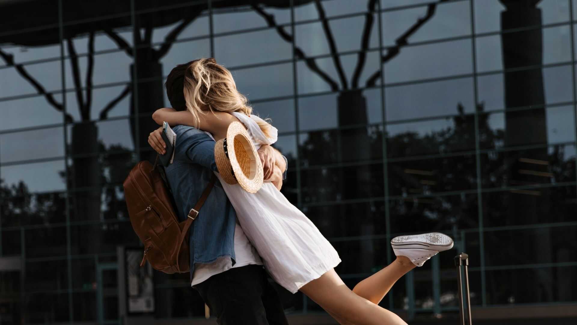 Pareja abrazándose en la terminal del aeropuerto tras llegar en un vuelo chárter privado.